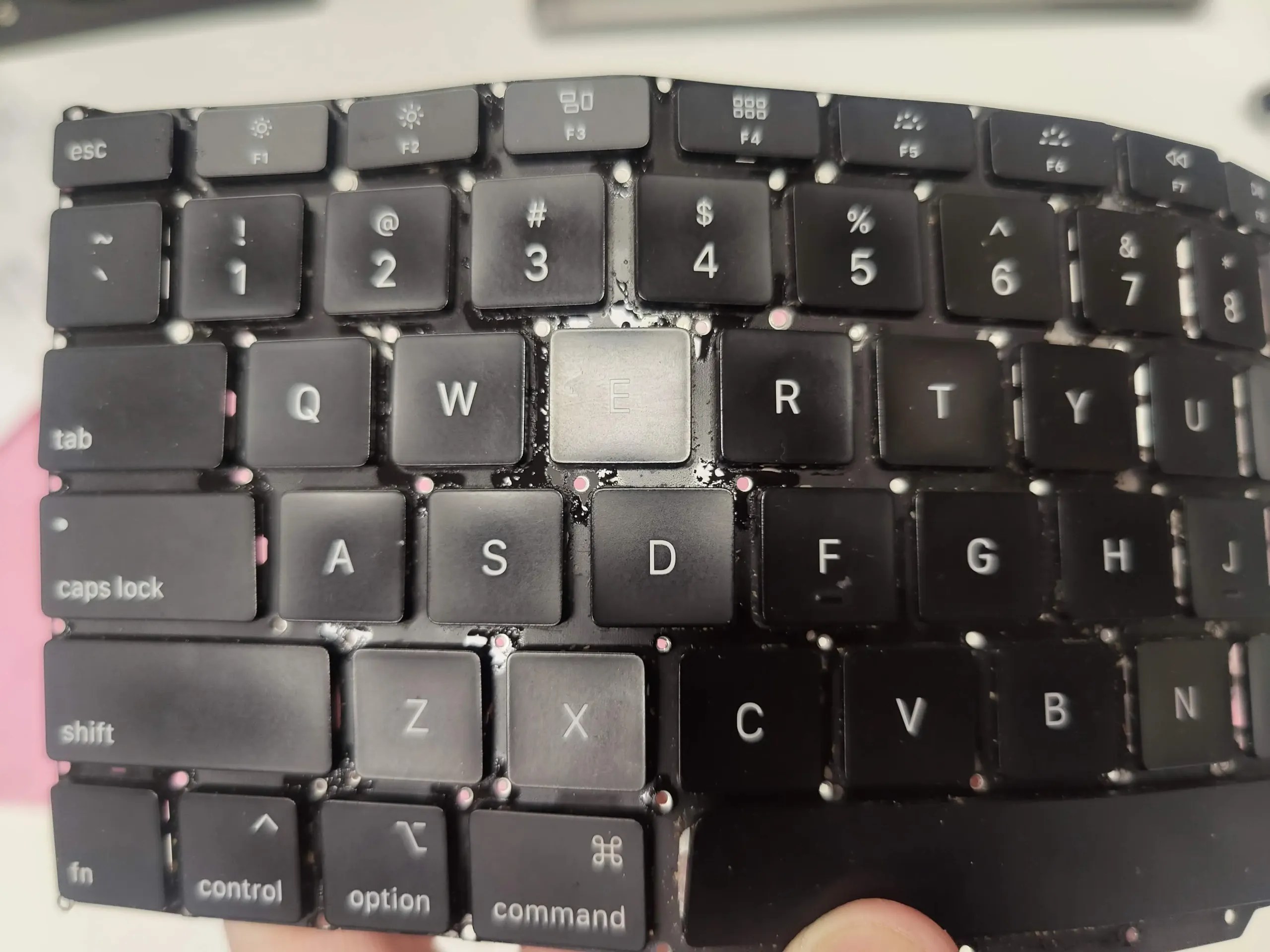 Sticky liquid residue on Apple MacBook Air M1 keyboard